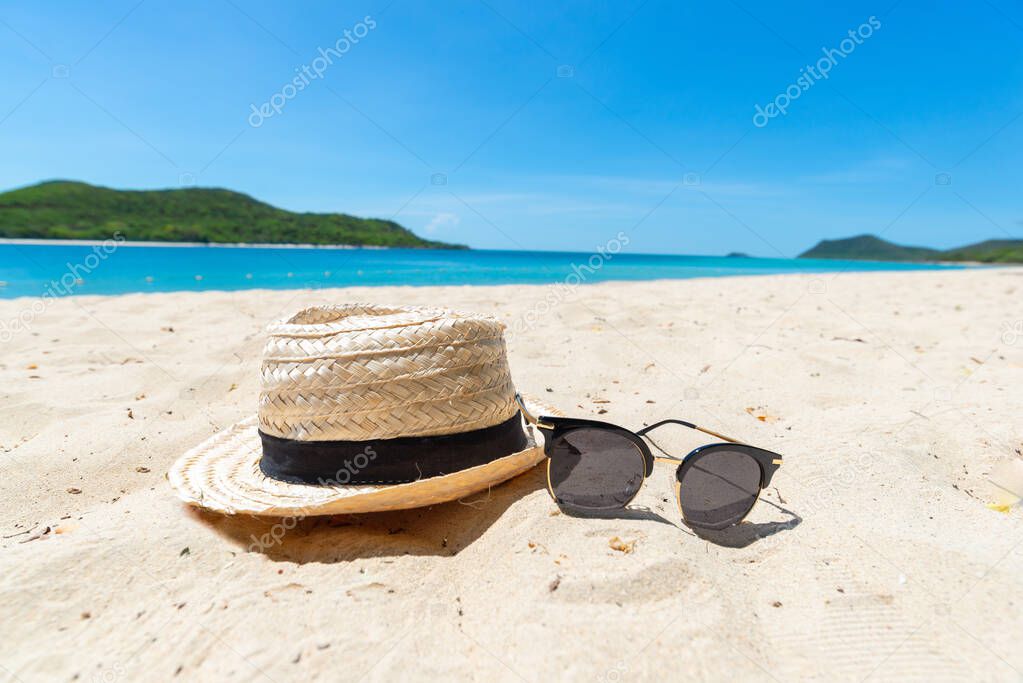 Straw Hat and sunglasses on the Sea background. beautiful sand beach as summertime, Travel and vacation concept. Holiday concept. Copy space for message.