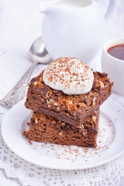 Chocolate cake with nuts and whipped cream