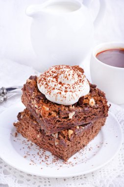 Chocolate cake with nuts and whipped cream
