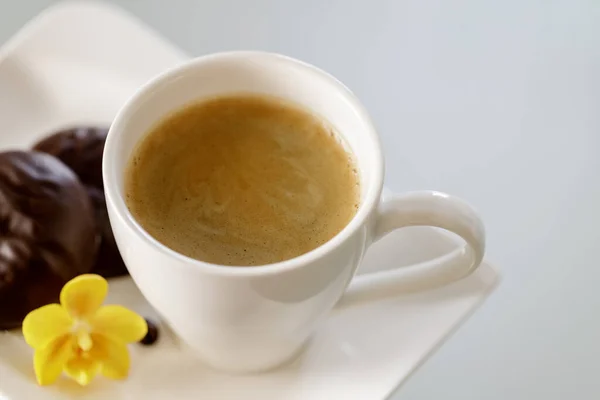 Cup of coffee from above on glass table. Light background with copy space