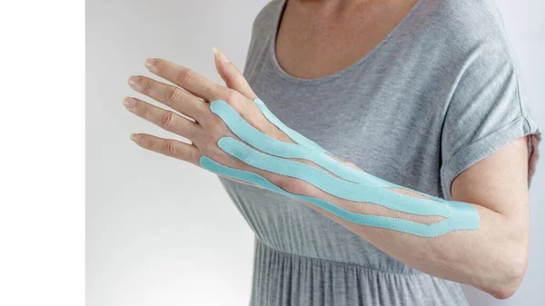 Female Arm Blue Medical Moisture Resistant Kinesio Elastic Tape Protect — Stock Photo, Image