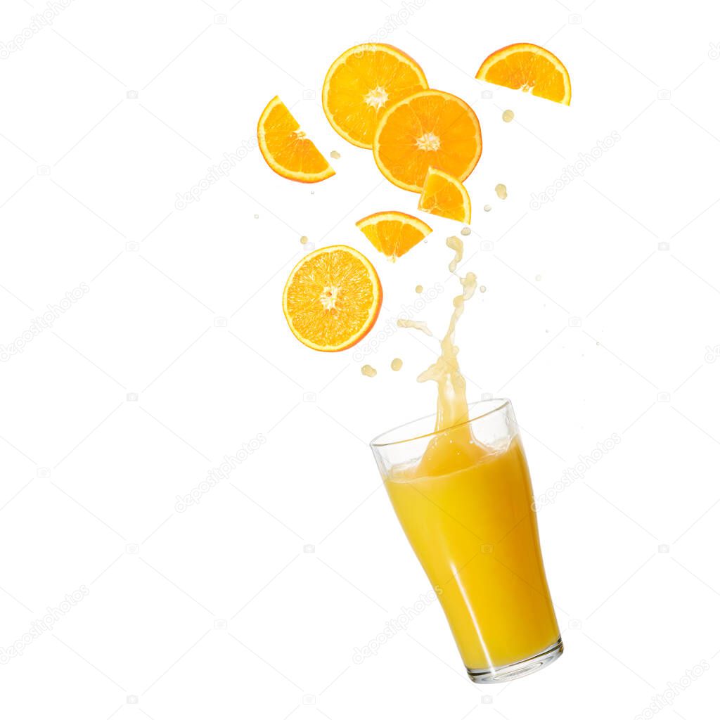 Orange fruit slices and juice glass with splash flying falling isolated on white backgroun