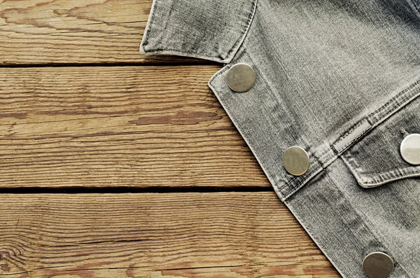 Jeans jacket on a wooden background — Stock Photo, Image