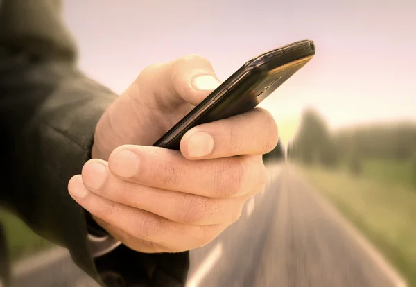 Close up of a man using mobile smart phone outdoor — Stock Photo, Image
