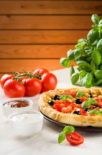 Pizza on wooden table — Stock Photo, Image