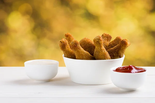 Chicken wings and sauces on the table — Stock Photo, Image