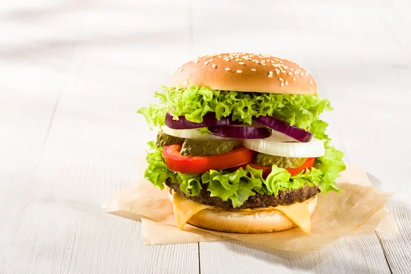 Homemade burger on the wooden table — Stock Photo, Image
