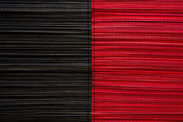 Vermelho e preto esteira de bambu textura ou fundo — Fotografia de Stock