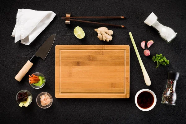 Asian food ingredients and cutting board top view — Stock Photo, Image