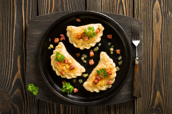 Fried dumplings with onion and bacon top view — Stock Photo, Image