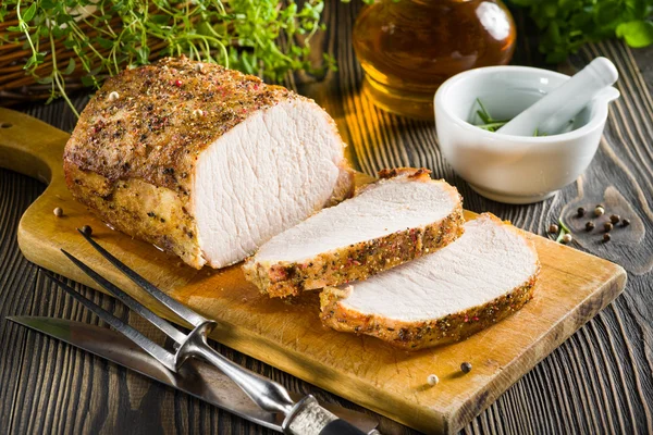 Roasted pork loin on the wooden table — Stock Photo, Image