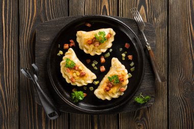 Fried dumplings with onion and bacon top view clipart