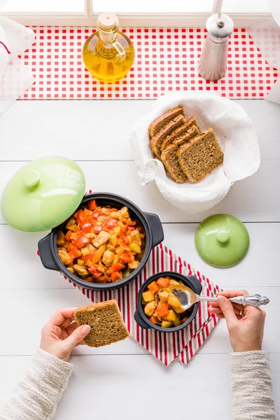 Woman eating warming soup in the kitchen — Stock Photo, Image