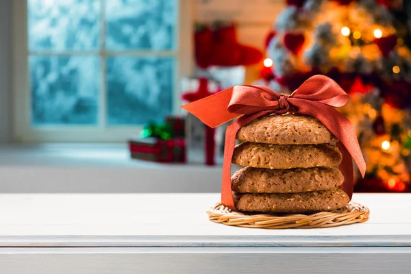 Christmas cookies packed red ribbon on a wooden table — Stock Photo, Image