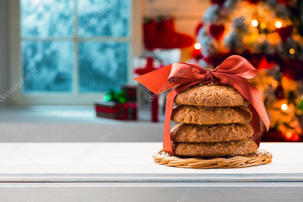Christmas cookies packed red ribbon on a wooden table