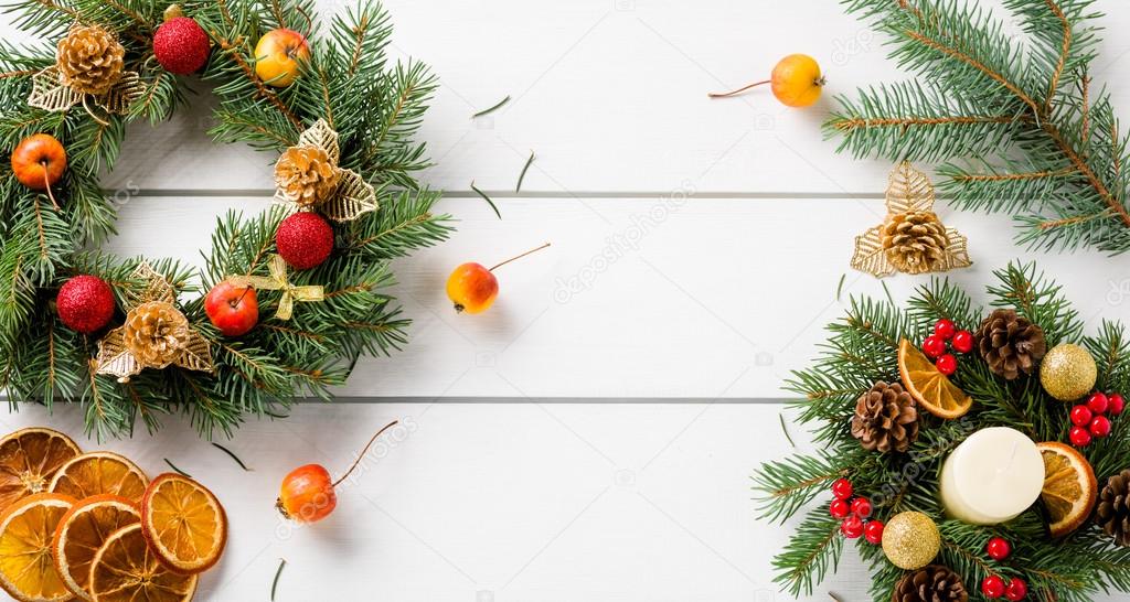 Christmas wreath on white wooden table top view