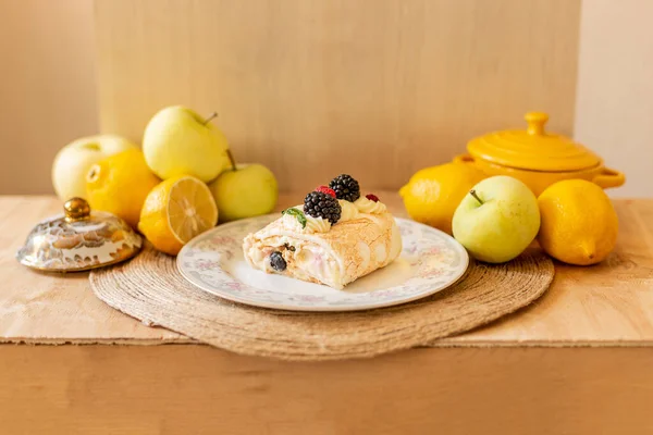 Meringue roll, summer mood, roll with berries on a light background