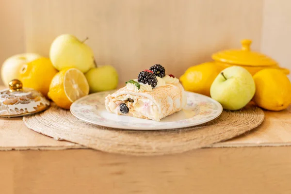 Meringue roll, summer mood, roll with berries on a light background