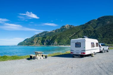 Trailer caravan in Kaikoura beach,New Zealand. clipart