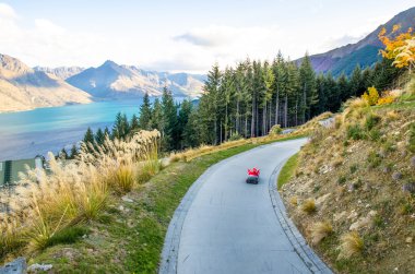 İnsanlar kızak araba Queenstown manzarası, Yeni Zelanda'oynarken görülebilir.