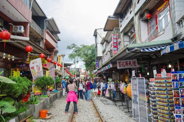 The Shifen Old Street section of Pingxi District has become one of the famous tourist stops along this line. People can seen exploring around it.