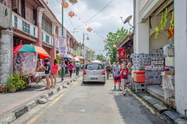 People can seen buying and exploring in front of souvenir stall in the street art in Georgetown, Penang