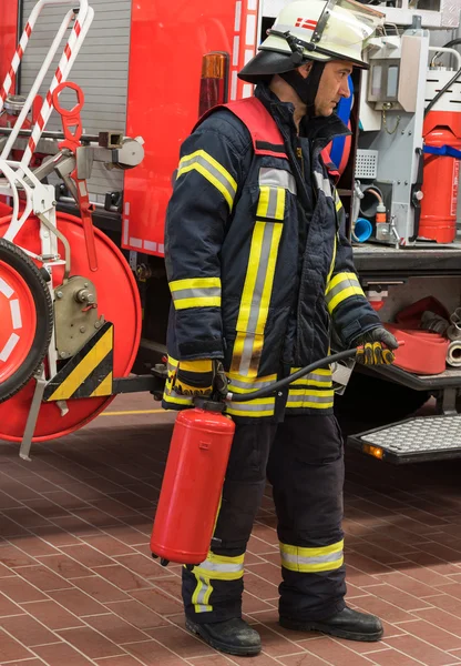 Feuerwehrmann im Einsatz und setzte einen Feuerlöscher ein — Stockfoto