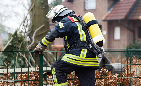 Brandweerman in actie buiten met zuurstof cilinder — Stockfoto