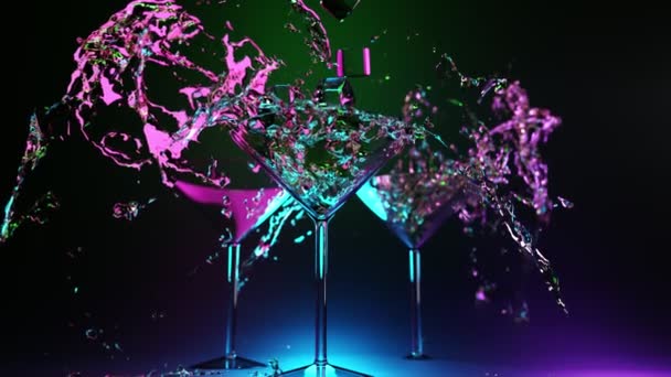 Martinis poharak alkoholos, sokszínű italokkal. Fagyasztott kék lila koktél fröcsköl jégkockákkal fekete háttéren. Hűtött party serlegek, robbanásszerű folyadék, 3D animáció. — Stock videók