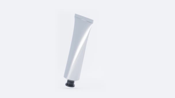 Metallic tube with hand cream or paints. Cosmetic aluminium container with black plastic cap, blank metal silver pack glue, toothpaste or medicine ointment on white background, 3d animation mock up. — Stock Video