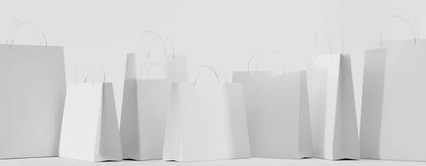 Bolsas de compras de papel blanco para llevar maqueta para llevar. Paquetes de regalo en blanco con asas rectangulares y cuadradas aisladas sobre fondo. Plantilla para diseño corporativo en bolsa de cartón para tienda o mercado — Foto de Stock