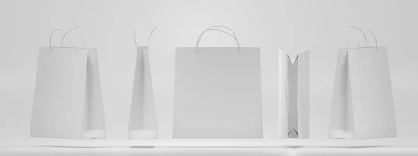 Bolsas de compras de papel blanco frente, lado, parte superior y vista angular se burlan. Paquetes de regalo cuadrados vacíos con asas sobre fondo aislado. Embalaje rectangular para el diseño de identidad corporativa. Conjunto realista 3d — Foto de Stock