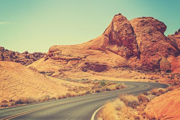 Vintage toned picture of a scenic winding road, USA — Stock Photo, Image