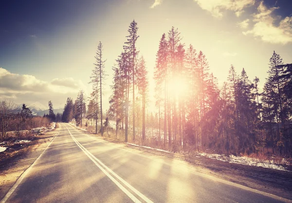 Vintage stylized country road at sunset. — Stock Photo, Image