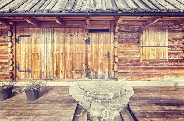 Vintage toned close up of a mountain cabin front wall. — Stock Photo, Image