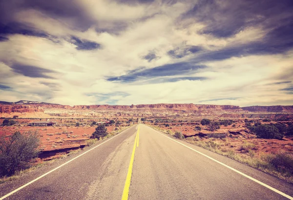 Vintage stylized picture of a scenic desert road. — Stock Photo, Image