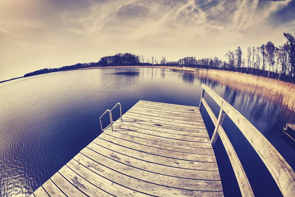 Vintage tonas fisheye-objektiv bild av en pir. — Stockfoto