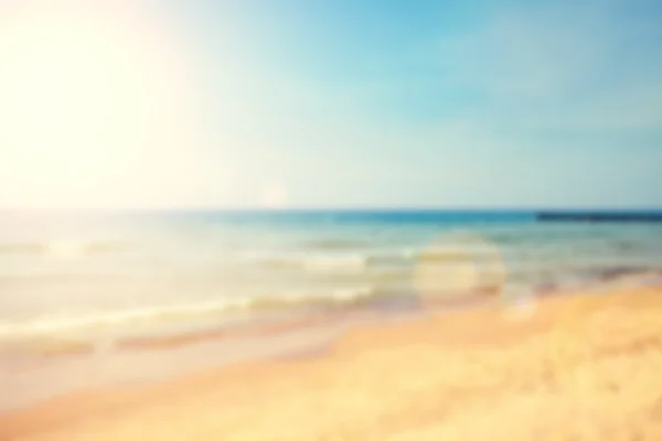 Playa borrosa con efecto de destello de lente, fondo natural — Foto de Stock