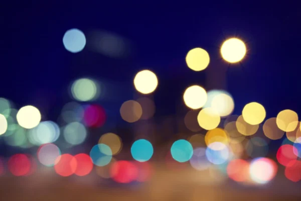 Vintage toned blurred street lights at night. — Stock Photo, Image