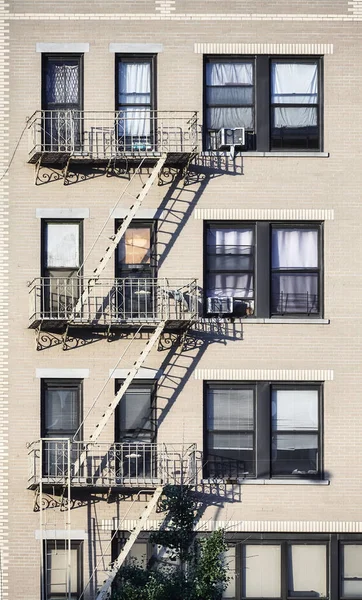 Old townhouse building with iron fire escape, New York City, USA.