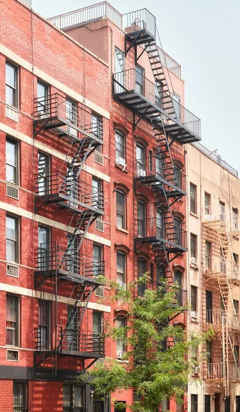 Row of old buildings with fire escapes, New York City, USA.