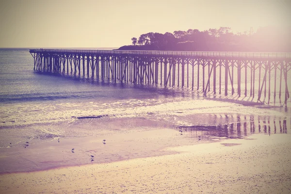 Vintage houten brug bij beach zonsondergang, Californië, VSA. — Stockfoto