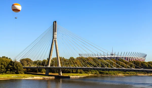 Bridge, hot-air balloon and stadium over Vistula river in Warsaw — Stock Photo, Image