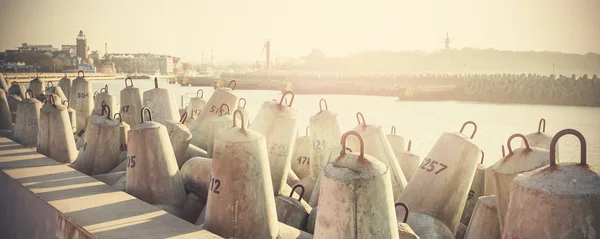 Retro filtered photo of concrete block breakwater. — Stock Photo, Image