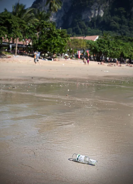 Leere Flasche am Strand, Tourismus- und Umweltkonzept. — Stockfoto