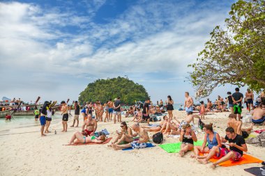 Small island crowded with tourists. clipart