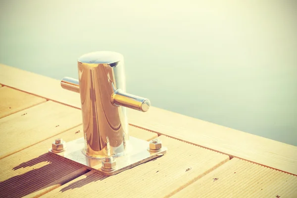 Vintage retro toned marina bollard. — Stock Photo, Image