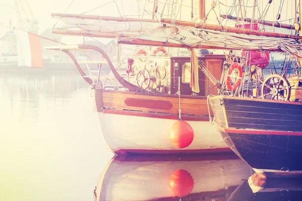 Vintage stylized photo of old sailing boats at sunrise. — Stock Photo, Image