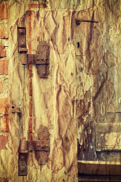 Rusty hinge on old wooden door, retro old paper effect. — Zdjęcie stockowe