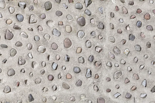 Pedras reais na parede de cimento, fundo abstrato natural . — Fotografia de Stock